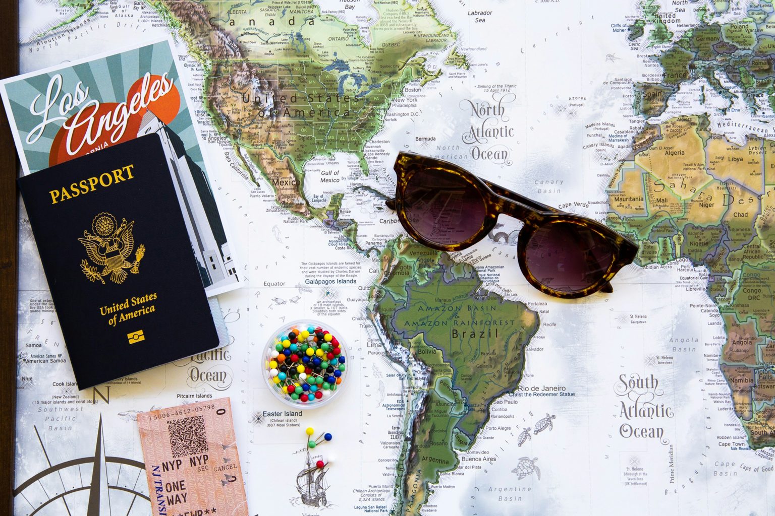 An image of a map with passport and glasses