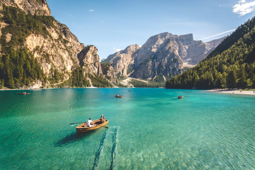 An image of boats in water around mountains