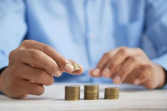 An image of a man counting coins